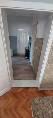 an empty room with a hallway with wood floors at Apartman VRANJANKA in Vranje