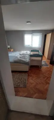 a bedroom with a bed and a window at Apartman VRANJANKA in Vranje