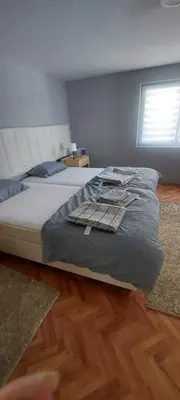 a large bed in a bedroom with a window at Apartman VRANJANKA in Vranje