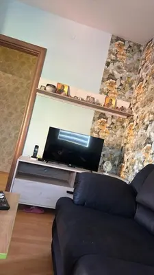 a living room with a couch and a flat screen tv at Apartman Teodora in Jagodina