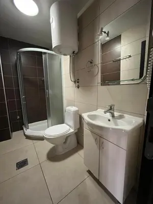 a bathroom with a toilet and a sink and a shower at Apartman 34, Kraljevi čardaci in Kopaonik