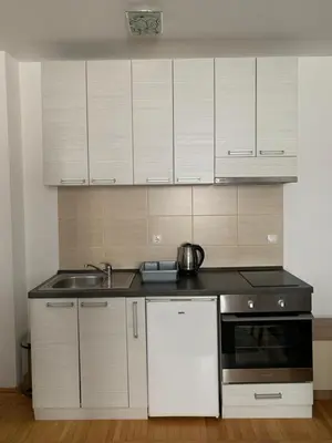a kitchen with white cabinets and a sink at Apartman 34, Kraljevi čardaci in Kopaonik