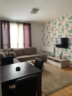 a living room with a couch and a table at Apartman 34, Kraljevi čardaci in Kopaonik