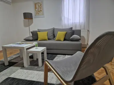 a living room with a couch and a table at Apartman DRINA in Vranje