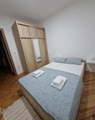 a bedroom with a bed with two towels on it at Apartman DRINA in Vranje
