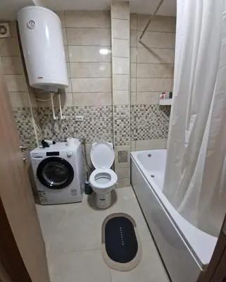 a small bathroom with a toilet and a bath tub at Apartman DRINA in Vranje