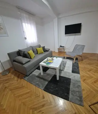 a living room with a couch and a table at Apartman DRINA in Vranje