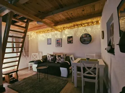 a living room with a couch and a table at Casa Vidica in Kopaonik