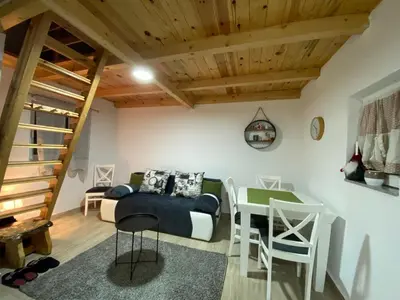 a bedroom with a bed and a table and chairs at Casa Vidica in Kopaonik