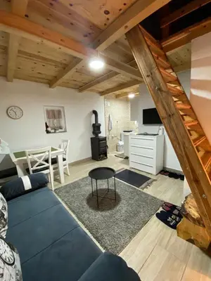 a living room with a blue couch and a table at Casa Vidica in Kopaonik