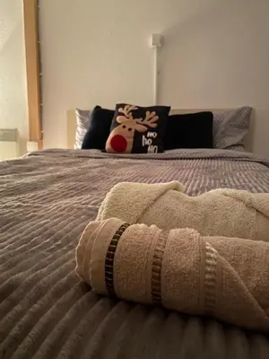 a bed with a blanket on top of it at Casa Vidica in Kopaonik