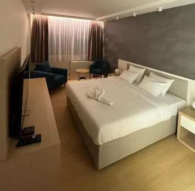 a bedroom with a bed with two white towels on it at Zepterme 511 in Vrnjačka Banja