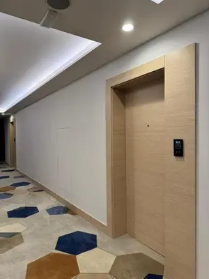 a hallway with a white wall and blue floors at Zepterme 511 in Vrnjačka Banja