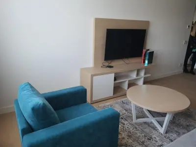 a living room with a blue couch and a table at Zepterme 511 in Vrnjačka Banja