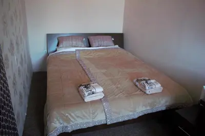 a bed in a bedroom with two phones on it at Garni Hotel City in Kruševac