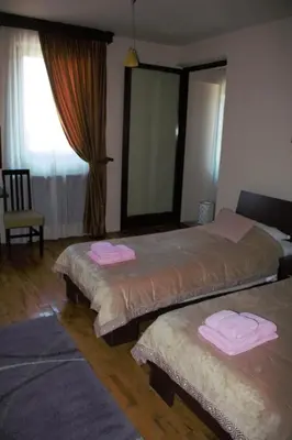 a bedroom with two beds with pink towels on them at Garni Hotel City in Kruševac