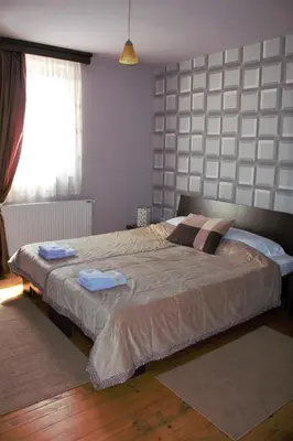 a bedroom with a bed with two towels on it at Garni Hotel City in Kruševac