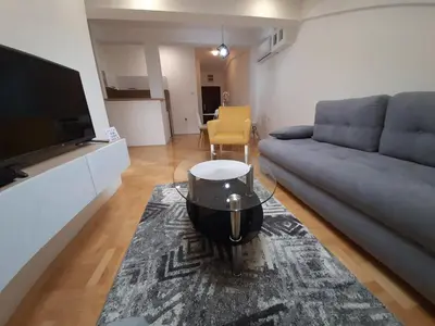 a living room with a couch and a tv at Heart of the city in Niš