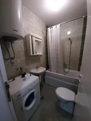 a bathroom with a toilet a sink and a shower at Heart of the city in Niš