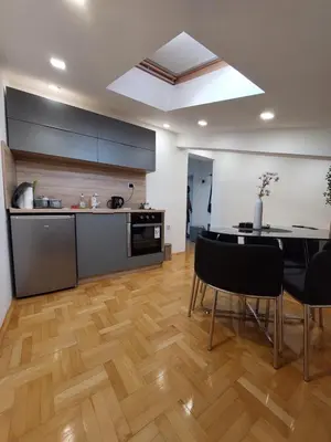 a kitchen and dining room with a table and chairs at Heart of the city in Niš