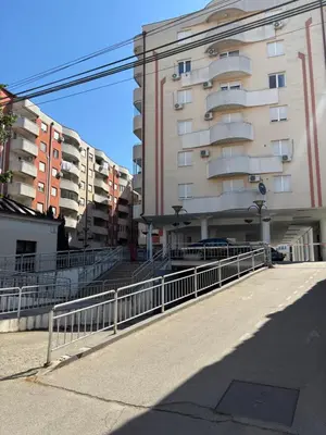 an empty street with a building and a fence at Heart of the city in Niš