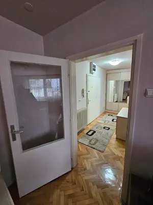 a room with a door leading to a bedroom at Apartman Maks 1 in Pirot