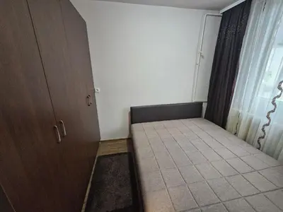 a small room with a bed next to a window at Apartman Maks 1 in Pirot