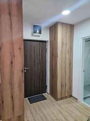 a room with a door and a tv on a wall at Pogled Contra in Kopaonik