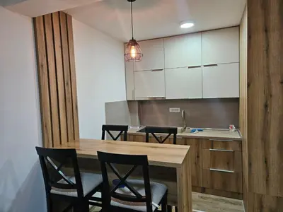 a kitchen with a wooden table and chairs at Pogled Contra in Kopaonik
