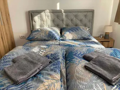 a bed with towels and pillows on it at Pogled Contra in Kopaonik