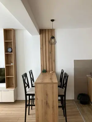 a dining room with a wooden table and chairs at Pogled Contra in Kopaonik