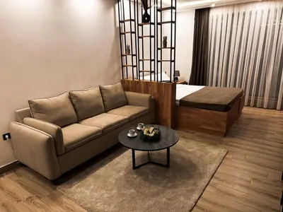 a living room with a couch and a table at Mokoš apartman, Residence hill A35, minimum dve noći in Kopaonik