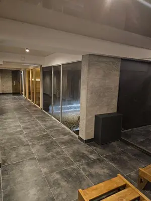 an empty lobby with a table and a television at Mokoš apartman, Residence hill A35, minimum dve noći in Kopaonik