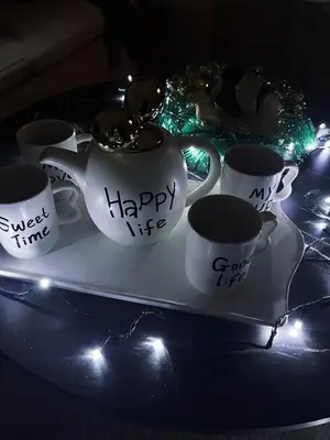 a tray with cups of coffee on a table with lights at Mokoš apartman, Residence hill A35, minimum dve noći in Kopaonik