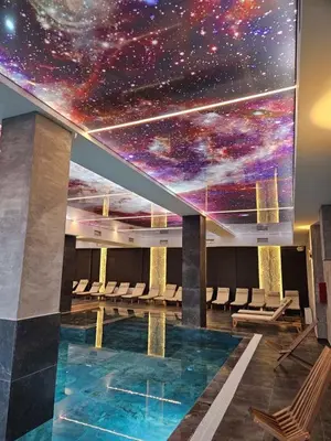 a room with a star ceiling and a swimming pool at Mokoš apartman, Residence hill A35, minimum dve noći in Kopaonik