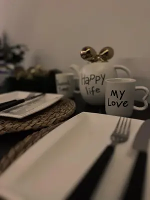 a table with a plate and a fork and a coffee cup at Mokoš apartman, Residence hill A35, minimum dve noći in Kopaonik