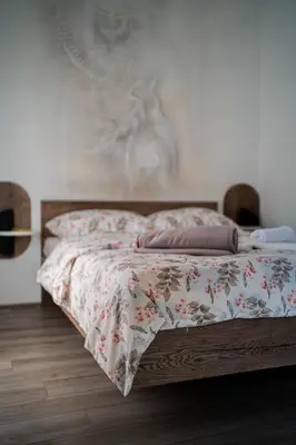 a bedroom with a bed with a floral bedspread at Angelina Art in Trnava