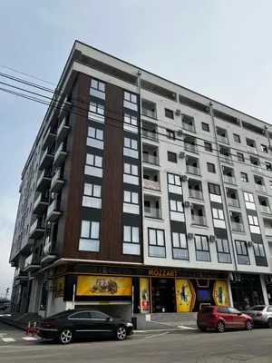 a large building with cars parked in front of it at Angelina Art in Trnava