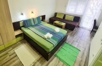 a small bedroom with a bed and a couch at Vila Aleksandra 2 Studio 5 in Soko Banja