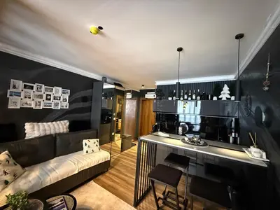 a living room with a couch and a bar at Black Elegant & Spa Kop in Kopaonik