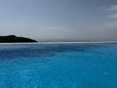 a large body of blue water next to a beach at Black Elegant & Spa Kop in Kopaonik