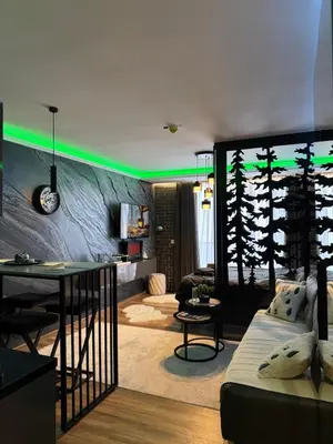 a living room with a couch and a table at Black Elegant & Spa Kop in Kopaonik