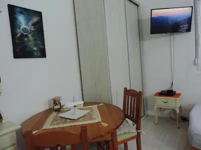 a small room with a wooden table and chairs at Apartman - kuca za odmor Slatina in Vrnjačka Banja