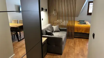 a living room with a couch and a bed at Bela Reka C308 in Brzeće