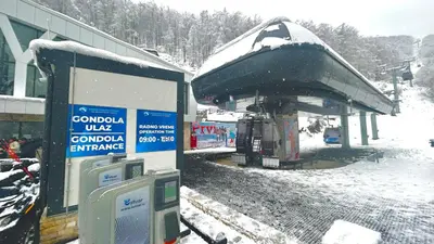 a gas station covered in snow next to a building at Bela Reka C308 in Brzeće
