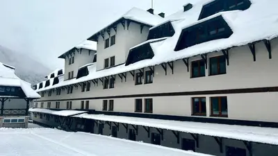 a building covered in snow with snow covered roofs at Bela Reka C308 in Brzeće