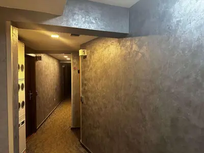 an empty hallway with a room with a wall at Konaci 25 Kopaonik in Kopaonik