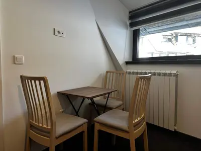 a small table and two chairs in a room at Konaci 25 Kopaonik in Kopaonik