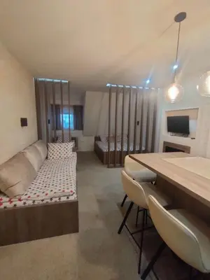 a living room with a couch and a table at Apartmani Iva Kop Konaci Koznik402 in Kopaonik