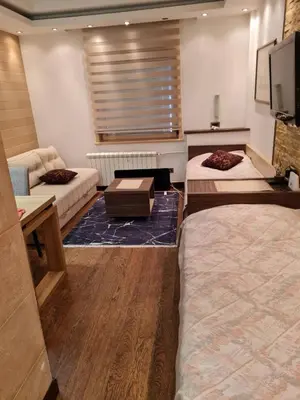 a hotel room with two beds and a tv at Apartmani Iva Kop Konaci Koznik402 in Kopaonik